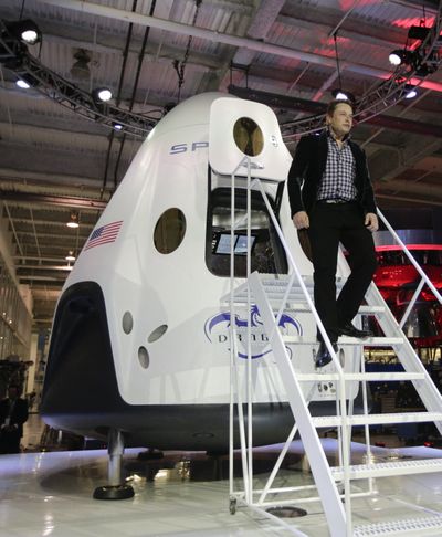 Elon Musk, of SpaceX, walks down the steps while introducing the SpaceX Dragon V2 spacecraft Thursday in Hawthorne, Calif. (Associated Press)