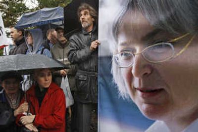 
Protesters stand near a portrait of Anna Politkovskaya during Sunday's rally in Moscow.Associated Press
 (Associated Press / The Spokesman-Review)