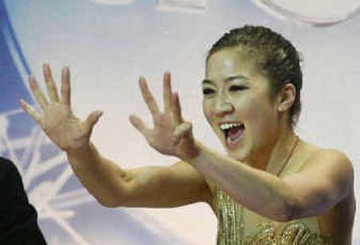 Michelle Kwan holds up nine fingers after winning her ninth title at the U.S. Figure Skating Championships. 
 (Associated Press / The Spokesman-Review)