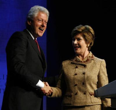 
First lady Laura Bush shakes former President Bill Clinton's hand after her speech Wednesday at the Clinton Global Initiative. 
 (Associated Press / The Spokesman-Review)
