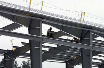 
Work continues on the Furniture Row building despite the snow and cold temperatures. 
 (J. BART RAYNIAK photos / The Spokesman-Review)