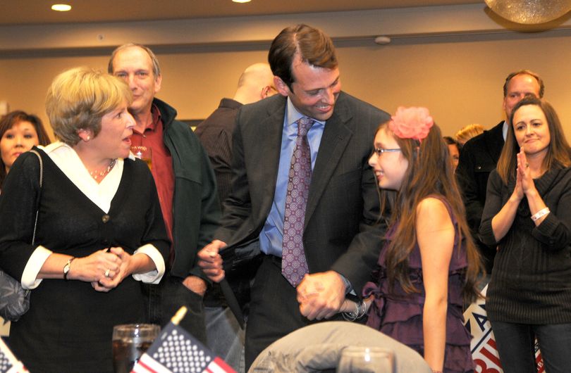 Andy Billig, center, and his daughter Isabella, 10, right, celebrate early returns that show him leading in a 3rd state legislative race on Tuesday, Nov. 2, 2010 at Lincoln Center in Spokane, Wash.  At left is Lisa Brown, the Democrat leader in the state senate. (Jesse Tinsley / The Spokesman-Review)