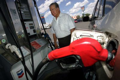 
Ignacio Cisneros fills his tank recently  at a Chevron gas station in El Paso, Texas, where he paid $2.99 a gallon. 
 (Associated Press / The Spokesman-Review)