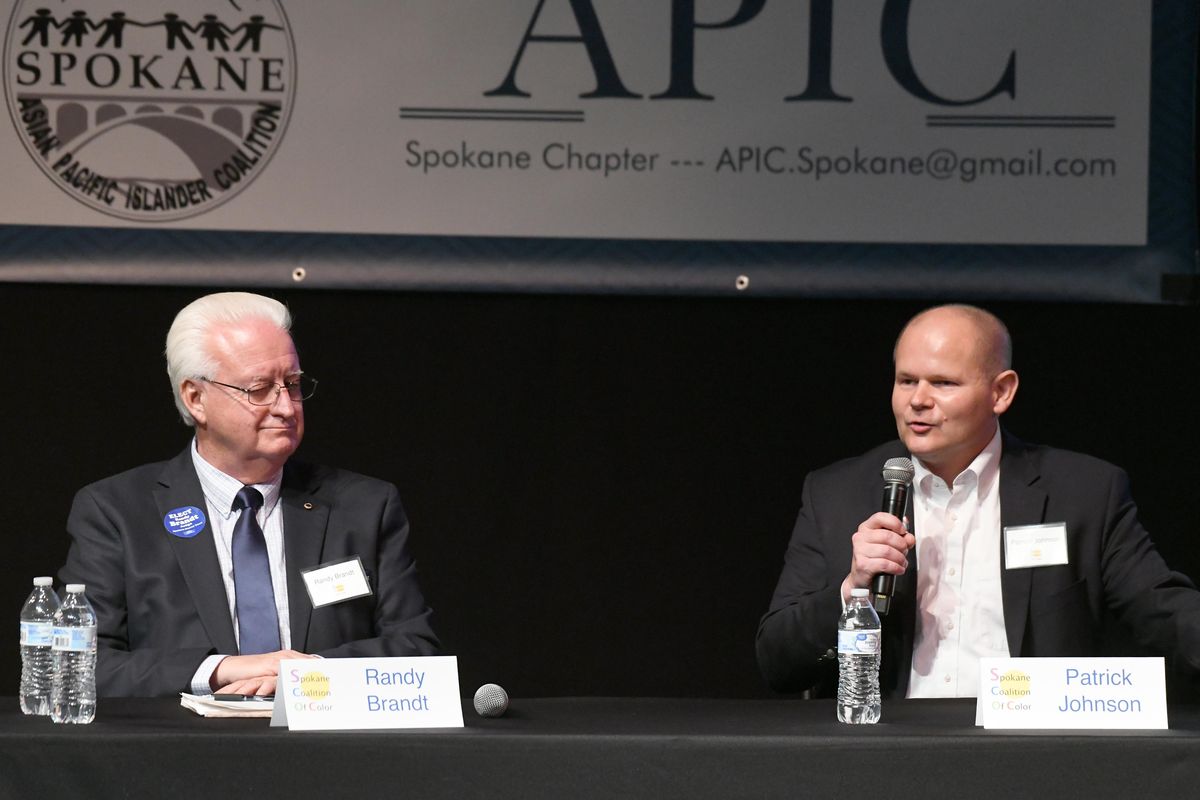 Candidates for Spokane County District Court judge, Randy Brandt, left, and Patrick Johnson, make their statements in front of the crowd at the Coalition of Color candidate forum Tuesday, Oct. 9, 2018 at Spokane Community College. (Jesse Tinsley / The Spokesman-Review)