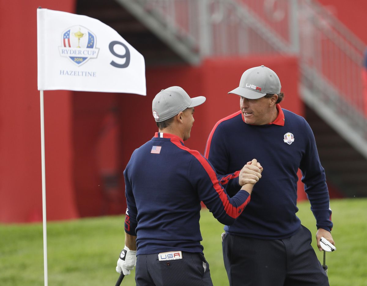 United States Phil Mickelson celebrates with teammate Rickie Fowler after Fowler chipped in on the ninth to win the hole during a foresomes match at the Ryder Cup golf tournament Friday, Sept. 30, 2016, at Hazeltine National Golf Club in Chaska, Minn. (David J. Phillip / Associated Press)