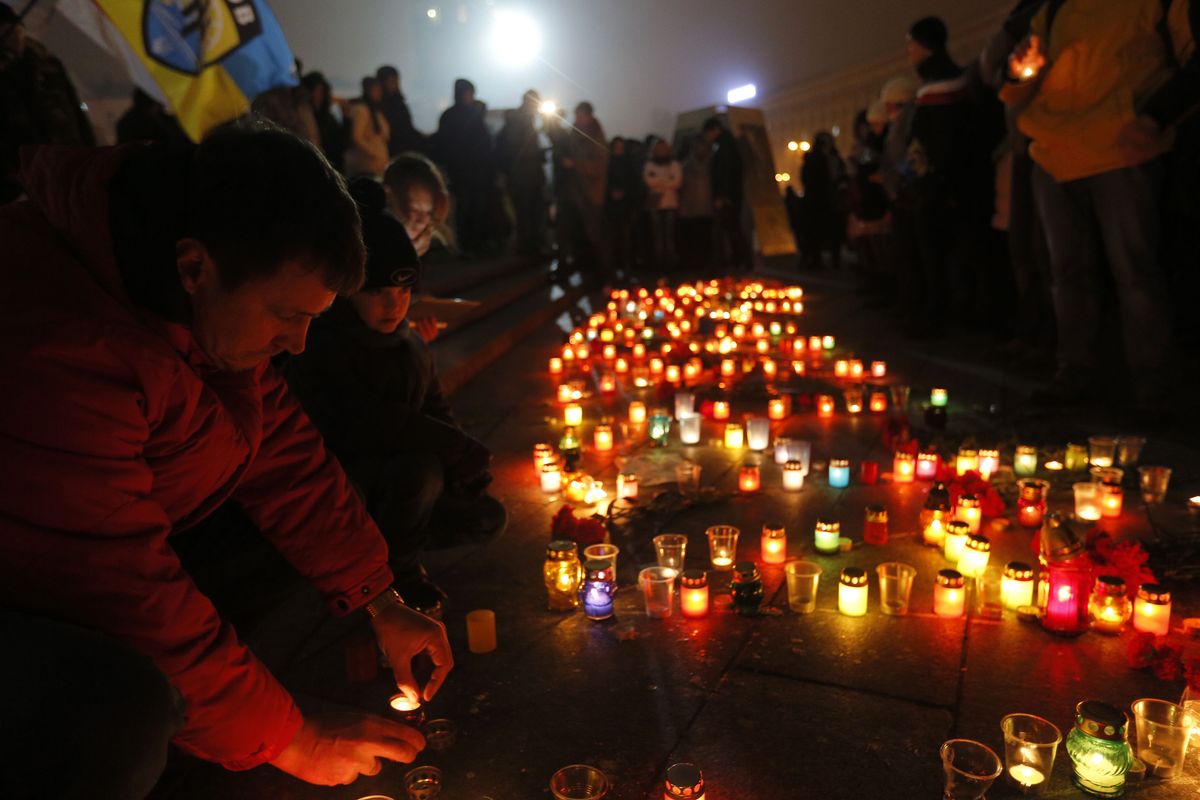 People light candles Saturday on Independence Square in Kiev, Ukraine, in solidarity with the victims of a rocket attack on the coastal city of Mariupol that claimed at least 30 lives. (Associated Press)