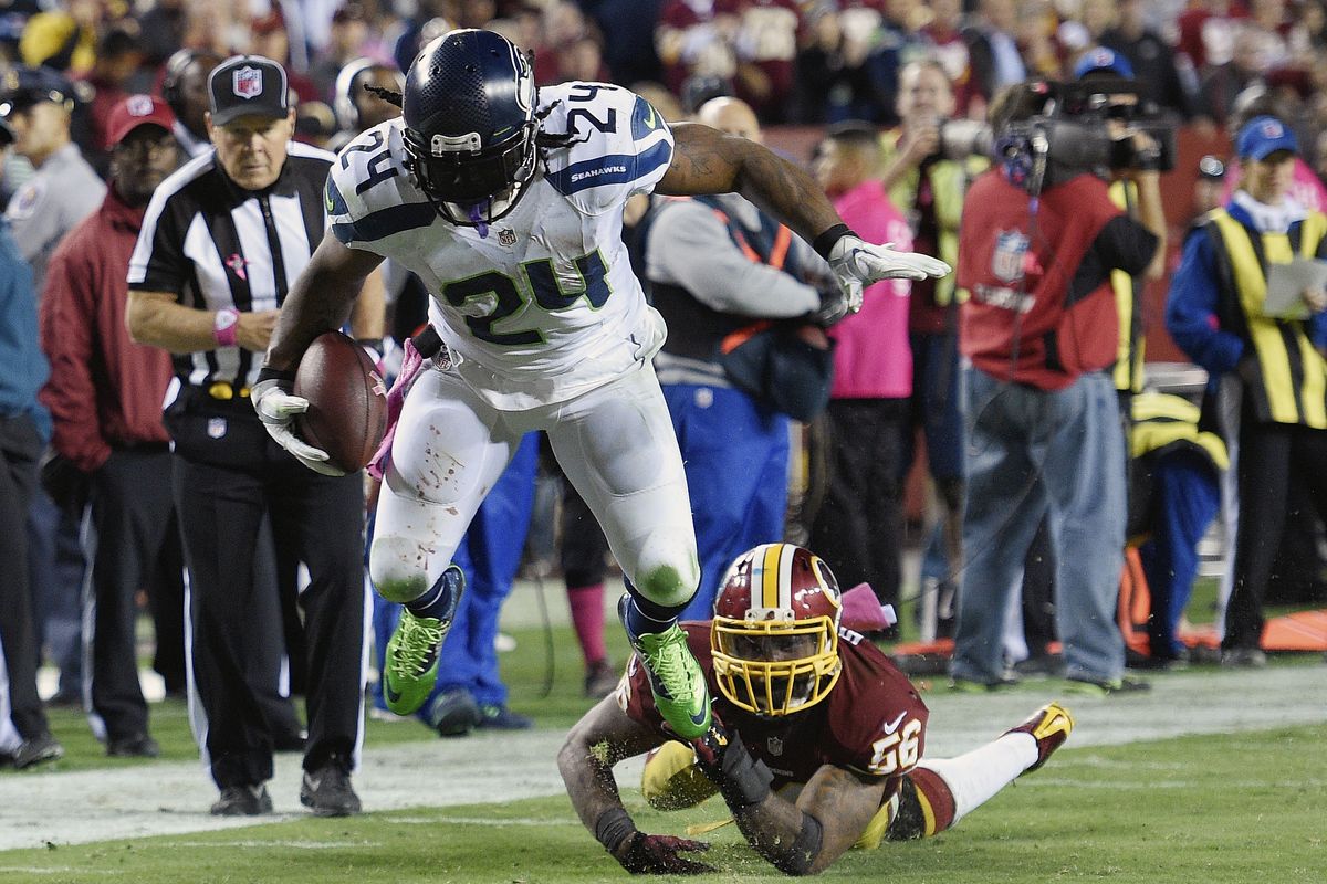 Seahawks running back Marshawn Lynch breaks a tackle by Washington’s Perry Riley on his way to a second-half touchdown. (Associated Press)
