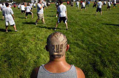 Freshman Beau Harter, 14, shows his dedication to Rogers High School football during training at Wednesday's practice.
(Jed Conklin / The Spokesman-Review)
