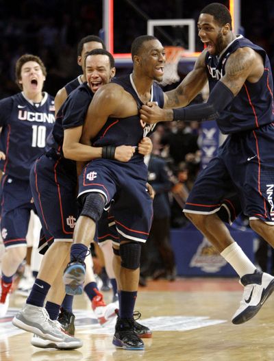 Connecticut's Kemba Walker, center, celebrates scoring the winning shot in the final seconds against No. 3 Pittsburgh. (Associated Press)