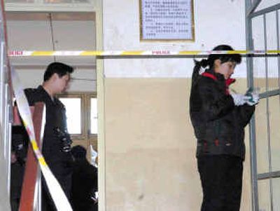 
Police investigators on Friday inspect the site of nine fatal stabbings at Ruzhou No.2 High School in Ruzhou, a city in central China's Henan Province.
 (Associated Press / The Spokesman-Review)
