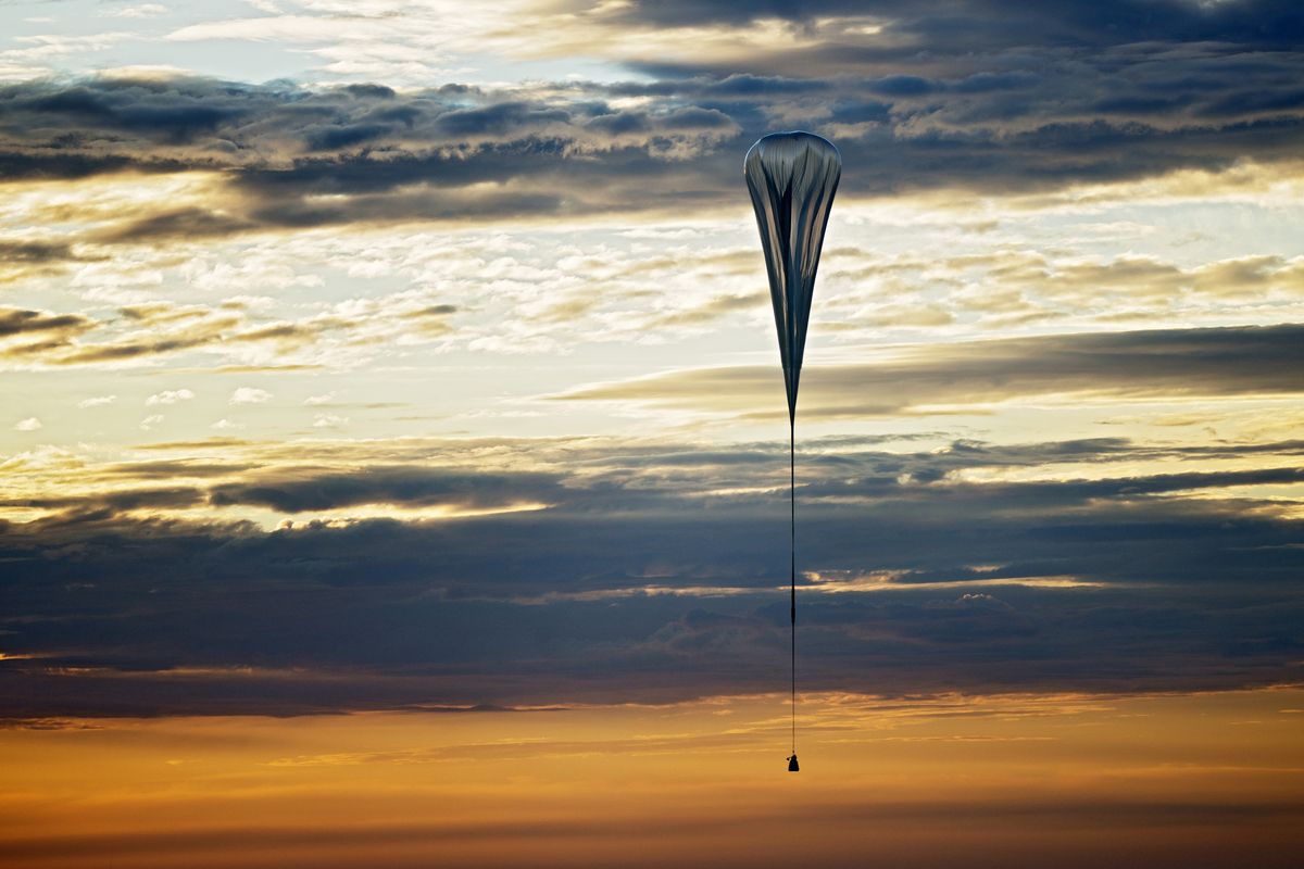 In this July 25, 2012 photo provided by Red Bull Stratos, a balloon lifts up during the second manned test flight for Red Bull Stratos in Roswell, N.M. It�s described as a �40-acre dry cleaner bag,� that, when first filled, will stretch 55 stories high. On Monday, this special ultra-thin helium balloon is scheduled to liftoff from Roswell, N.M., to carry "Fearless Felix" Baumgartner 23 miles into the stratosphere for what he hopes will be a history-making, sound barrier-breaking skydive. (Joerg Mitter / Red Bull Stratos)