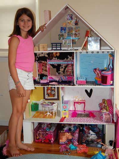 Author Laura Jofre’s daughter’s dollhouse features an eclectic collection of Barbie furniture, painted wood furniture, fabric floors and “doodle wall.” (Associated Press)