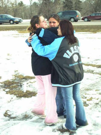 
Red Lake High School students weep together following Monday's deadly shooting rampage. 
 (Associated Press / The Spokesman-Review)