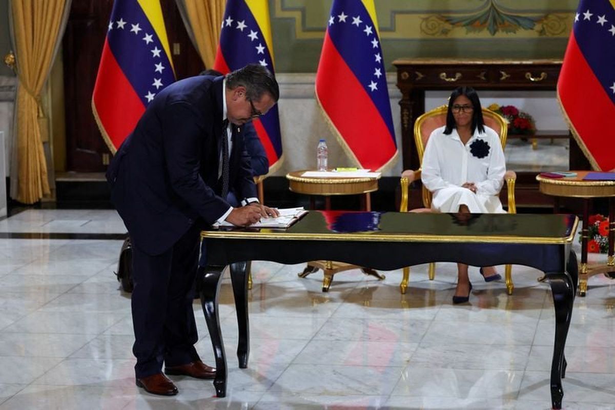 Venezuela’s interim President Delcy Rodriguez looks on Monday as Mariano Vela, president of Chevron in Venezuela, signs an oil agreement between Chevron and Venezuela’s state oil company PDVSA in Caracas, Venezuela. (Reuters )