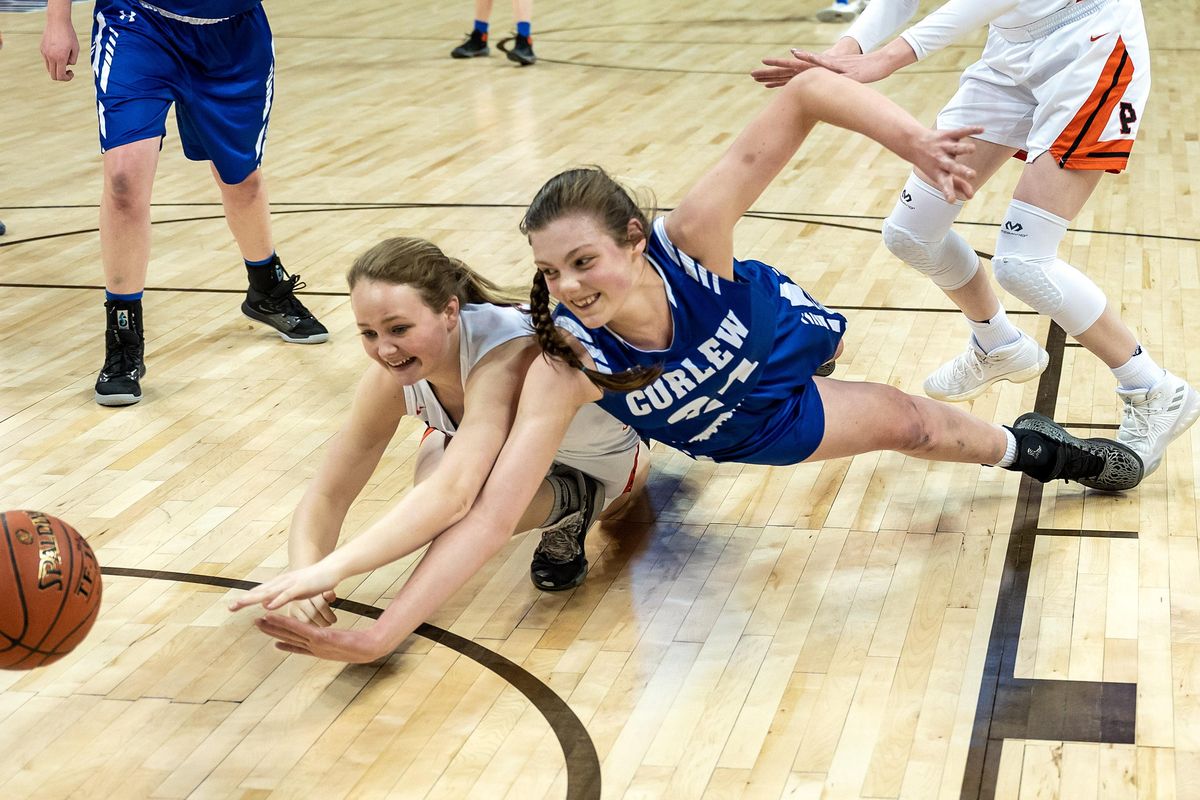 Pomeroy guard McKenzie Watko (on left) and Curlew forward Korin Baker (24) chase a loose ball during a WIAA State 1b Hardwood Classic basketball game, Thurs., March 5, 2020, in the Spokane Arena. (Colin Mulvany / The Spokesman-Review)