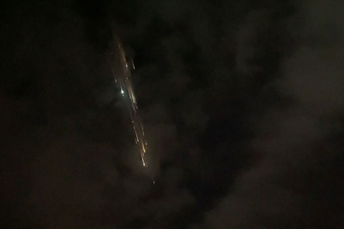 In this image taken from video provided by Roman Puzhlyakov, debris from a SpaceX rocket lights up the sky behind clouds over Vancouver, Wash. Thursday evening, March 25, 2021. The remnants of the second stage of the Falcon 9 rocket left comet-like trails as they burned up upon re-entry in the Earth