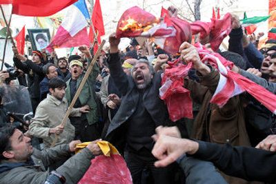 
Iranian protesters burn Danish and French flags in front of the Austrian Embassy in Tehran Monday. 
 (Associated Press / The Spokesman-Review)