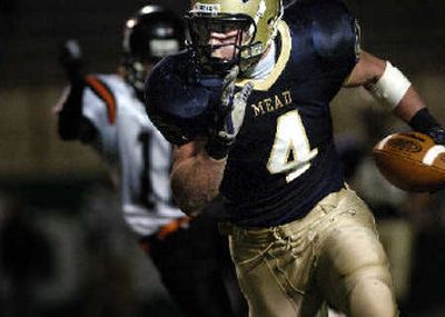 
Andy Mattingly had a huge night for Mead. Here the WSU-bound player takes off after making one of his four receptions against Lewis and Clark. He had one TD catch and also made a key interception on defense.
 (Holly Pickett / The Spokesman-Review)