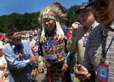 
Glen Douglas, dressed in his war bonnet, chats with a group of Native American veterans at the World War II memorial dedication in Washington, D.C. The veterans include Phillip W. Coon, far left, who survived the siege of Corregidor and the Bataan Death March.
 (Colin Mulvany / The Spokesman-Review)