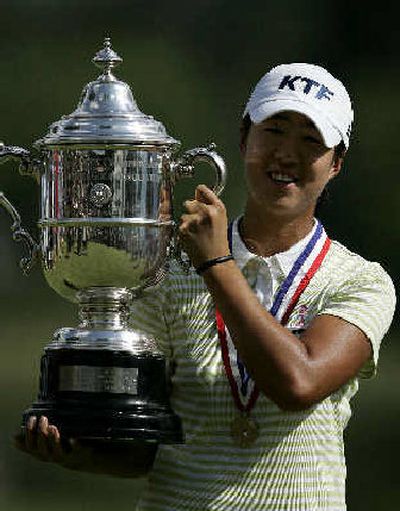 
South Korean Birdie Kim holds up the U.S. Women's Open trophy Sunday.
 (Associated Press / The Spokesman-Review)