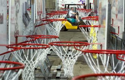 
Hoopfest staff member Mike Abbott  loads basketball hoops Wednesday for placement on Friday. Hoops have received repairs and been refurbished with new ads. 
 (Christopher Anderson / The Spokesman-Review)