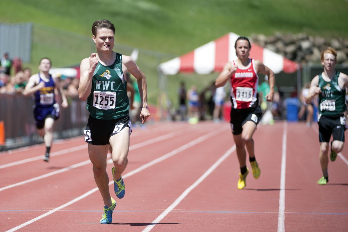 Jack Ammon, left, from Northwest Christian, edges out St. George’s Mitchell Ward, center, and NWC teammate Jacob VanGerpen, right, in the 400 meters. (Jesse Tinsley / The Spokesman-Review)