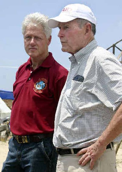 
Former Presidents Bush, right, and Clinton survey tsunami damage in Lampuuk, a village outside Banda Aceh, Indonesia, on Sunday. 
 (Associated Press / The Spokesman-Review)