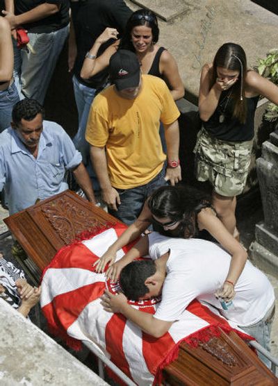 
Relatives cry during the funeral of Guaracy Paes Falcao, leader of the Salgueiro samba band,  in Rio de Janeiro on Thursday.  Gunmen killed Falcao early Wednesday. 
 (Associated Press / The Spokesman-Review)