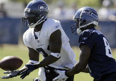 
Kelly Herndon, left, steps in front of Nate Burleson.
 (Jim Bryant Associated Press / The Spokesman-Review)