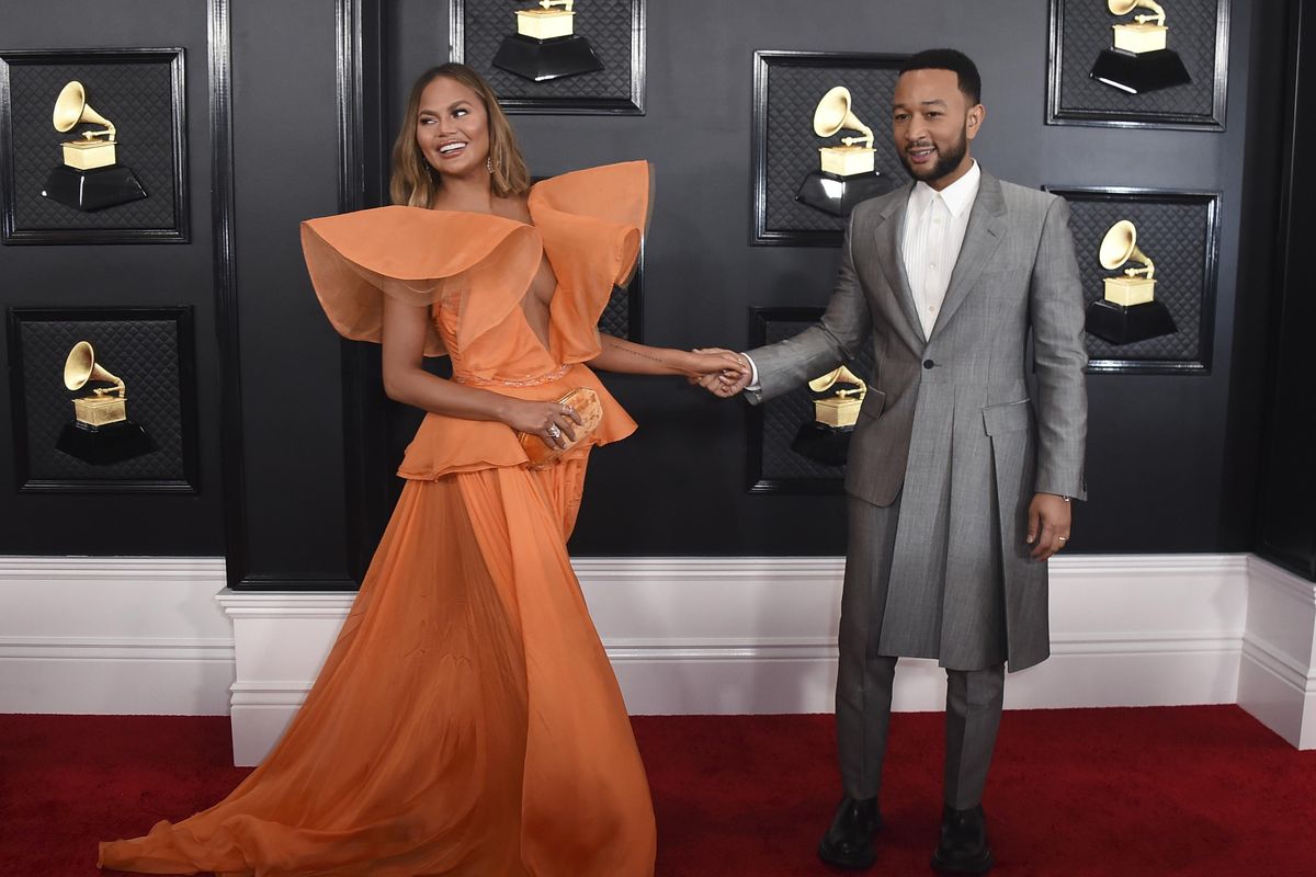 Chrissy Teigen, left, and John Legend arrive at the 62nd annual Grammy Awards at the Staples Center on Sunday, Jan. 26, 2020, in Los Angeles. (Jordan Strauss / Associated Press)