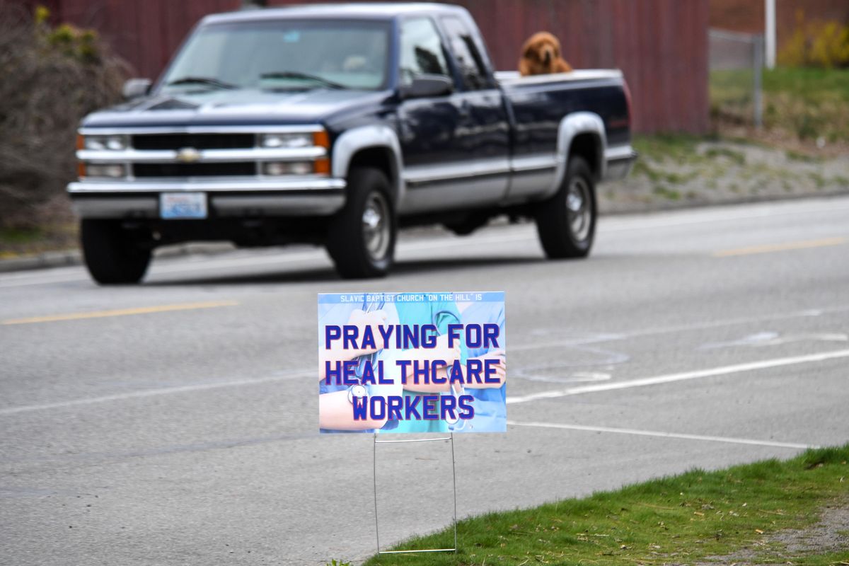 A sign by the Slavic Baptist Church, on the corner of Driscoll Boulevard and Hoffman Avenue in Spokane, asks for prayers for health care workers during the COVID-19 pandemic. Area museums are collecting mementos of the pandemic for preservation. (Dan Pelle / The Spokesman-Review)