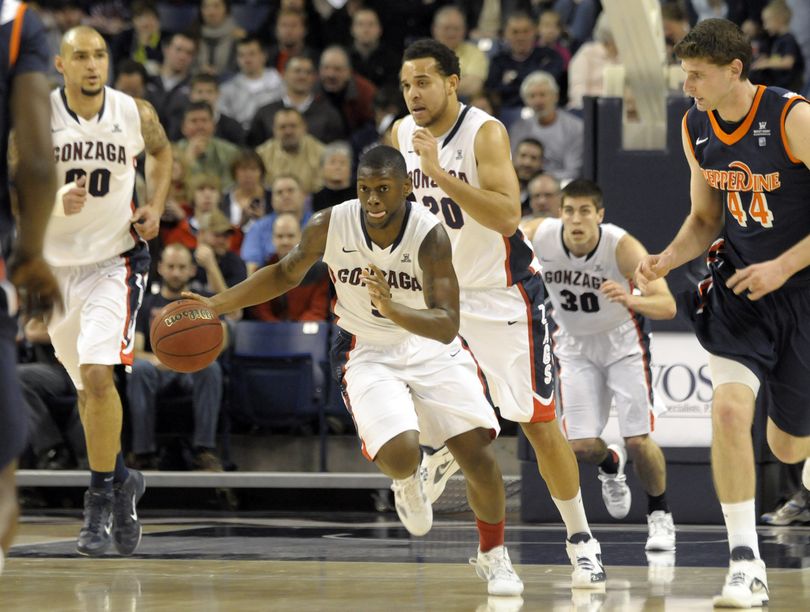 Gonzaga's Gary Bell Jr. (5) leads the charge with teammates Robert Sacre (00) Elias Harris (20) and Mike Hart (30) following as Pepperdine's Corbin Moore (44) also pursues in the first half of an NCAA college basketball game on Thursday, Jan. 5, 2012, in Spokane, Wash. Bell Jr. finished the game with a career-high 15 points. (Jed Conklin / Fr170252 Ap)