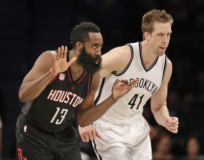 Houston Rockets' James Harden, left, reacts after making a basket while Brooklyn Nets' Justin Hamilton runs alongside him during the second half of the NBA basketball game at the Barclays Center, Sunday, Jan. 15, 2017 in New York. (Seth Wenig / Associated Press)