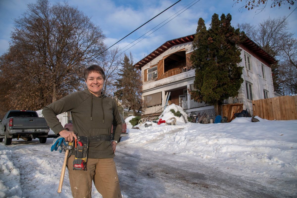 Shelly Bacon helps run Hope Street Restoration in Colville, a real estate flipping business, where she and her husband refurbish homes and sell them, hiring and training people who have been homeless, addicted or in prison. She is standing in front of a Colville mansion that she and a handful of homeless employees are working on.  (Jesse Tinsley/The Spokesman-Review)