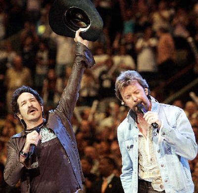 Kix Brooks and Ronnie Dunn of Brooks & Dunn sing the national anthem prior to the start of Game 7 of the NBA finals in San Antonio in June. 
 (Associated Press / The Spokesman-Review)