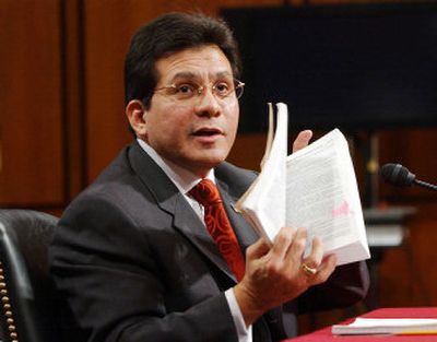 
Attorney General Alberto Gonzales holds a book dealing with the Foreign Intelligence Surveillance Act before the Senate Judiciary Committee on Monday. 
 (Associated Press / The Spokesman-Review)