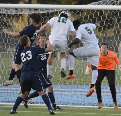 Shadle Park’s Peter Sokolis (5) scores the game’s first goal, a header off a corner kick, at SFCC on Wednesday. (Colin Mulvany)