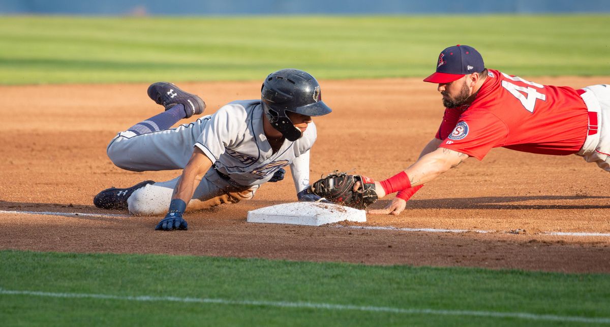 Tre Carter of the Tri-City Dust Devils dives safely to third base against Jake Hoover of the Spokane Indians during a game on Monday, July 8, 2019 at Avista Stadium. The Dust Devils beat the Indians 6-5.