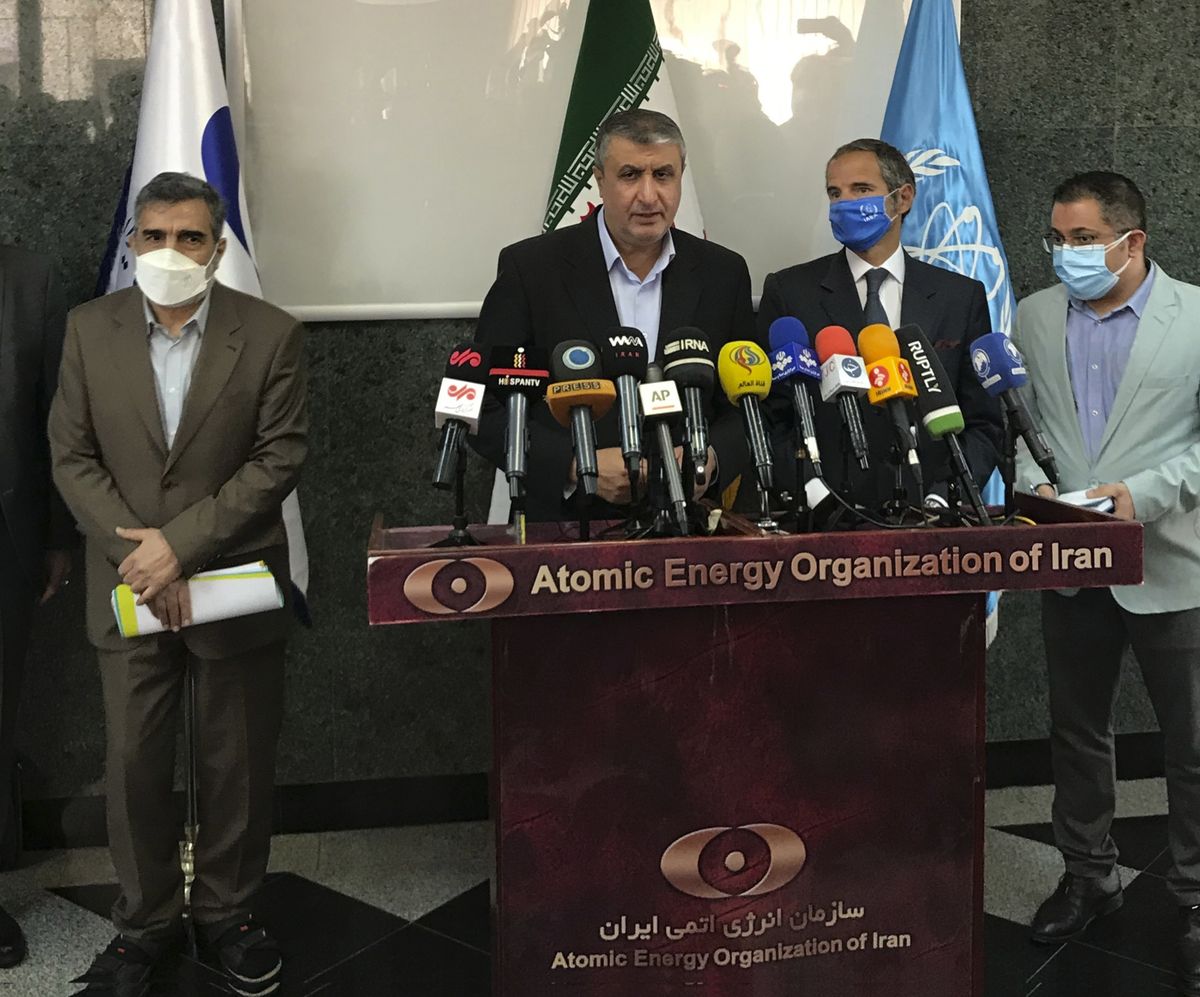 Head of Atomic Energy Organization of Iran, Mohammad Eslami, center, speaks during a joint press briefing with Director General of International Atomic Energy Agency, IAEA, Rafael Mariano Grossi, second right, in Tehran, Iran, Sunday, Sept. 12, 2021. Iran agreed Sunday to allow international inspectors to install new memory cards into surveillance cameras at its sensitive nuclear sites and to continue filming there, averting a diplomatic showdown this week.  (HOGP)
