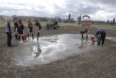 
The Spokesman-ReviewWest Valley head softball Coach Paul Cooley drags the Eagles infield as the team removes puddles of water with buckets and shovels March 17. Players and their parents recently edged and prepared the dismond for the upcoming season.
 (J. BART RAYNIAK / The Spokesman-Review)
