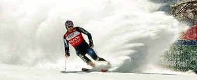 American Bode Miller kicks up a cloud of snow as he puts on the brakes during a practice run.
(Associated Press / The Spokesman-Review)