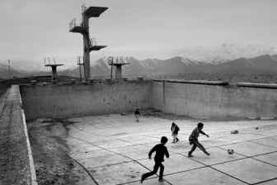 
 Afghan boys play soccer in war-damaged Soviet occupation-era swimming pool in Kabul on Saturday. 
 (Associated Press / The Spokesman-Review)