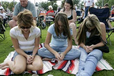 
From left, Dannette Moynier, Dannette's daughter McKenzie and McKenzie Harbel pray for the six trapped coal miners during a fundraiser Sunday in Price, Utah.Associated Press
 (Associated Press / The Spokesman-Review)