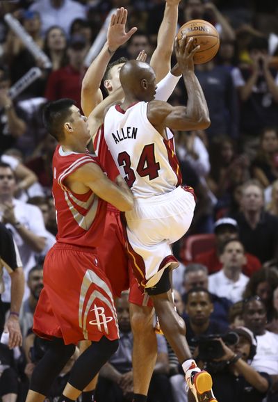 Rockets Jeremy Lin, left, and Donatas Motejunas defend the Heat’s Ray Allen during the second half. (Associated Press)