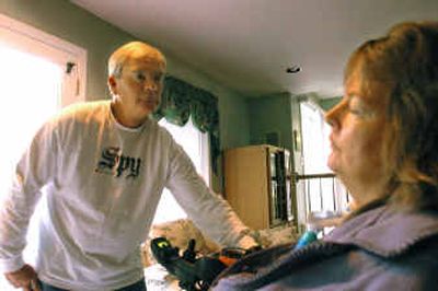 
Doug Grace assists his sister, Saundra Dorosh, on Wednesday. She was paralyzed from the neck down from a  pool accident. 
 (Jesse Tinsley / The Spokesman-Review)