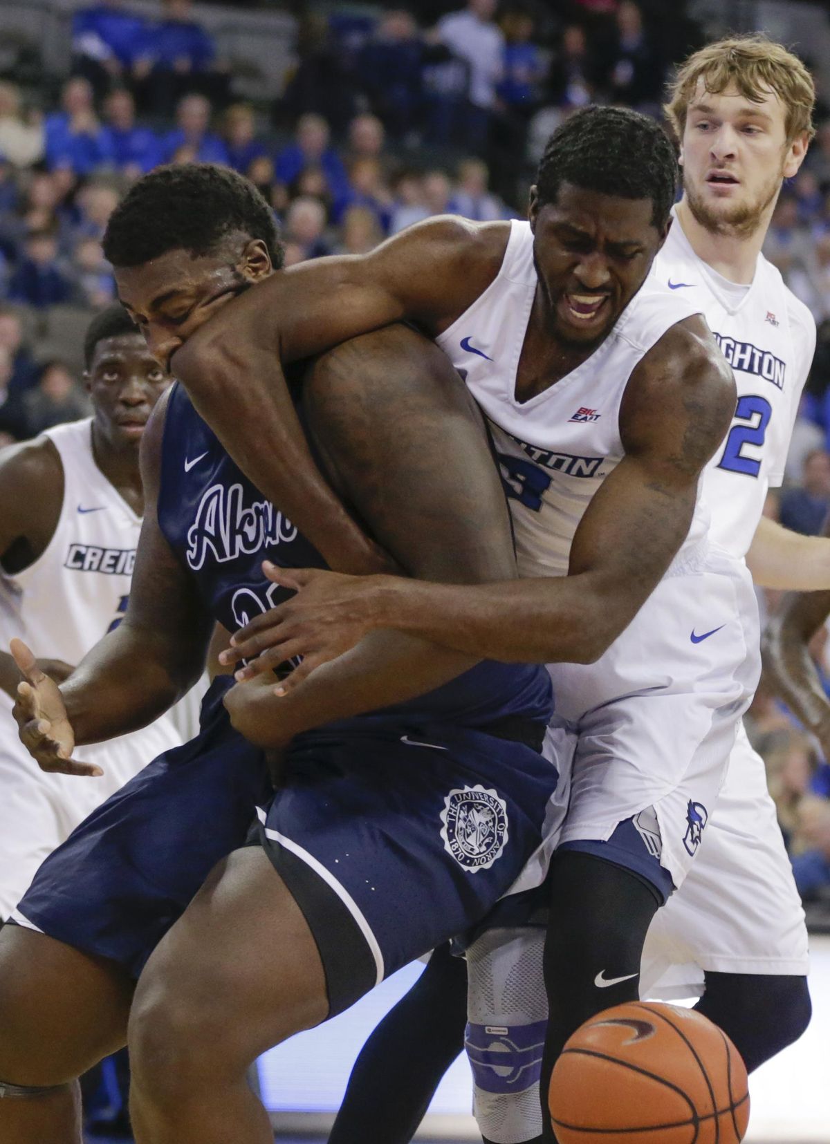 Akron’s Isaiah Johnson, left, and Creighton’s Cole Huff (13) struggle for a loose ball during the first half of an NCAA college basketball game in Omaha, Neb., Saturday, Dec. 3, 2016. (Nati Harnik / Associated Press)