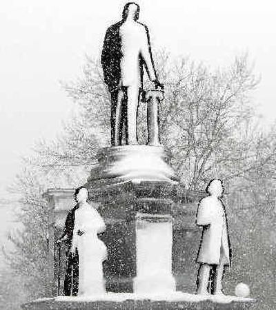 
Snow clings to statues on a monument in Denver's City Park on Sunday as a blizzard passed through the area. Flights were canceled and roads were closed. 
 (Associated Press / The Spokesman-Review)