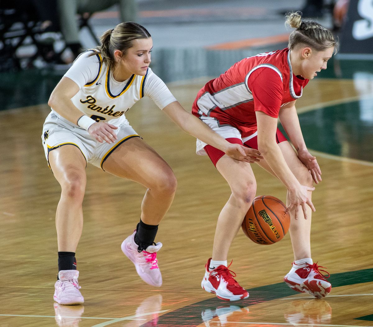 Mead’s Miah Cyr, left, attempts to steal the ball from Stanwood’s Grace Walker during a State 3A girls basketball tournament game Thursday in Tacoma.  (Patrick Hagerty)