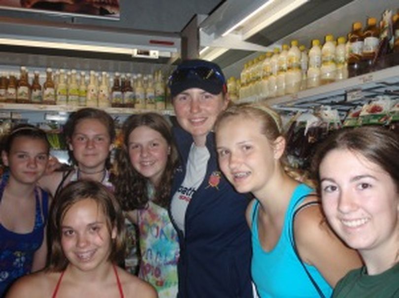  U.S. Women’s Rowing Team athlete Jamie Redman of Spokane poses with a group of North Central High School students the met by coincidence in the story at the Lucerne, Switzerland, train station. 
Redman, there competing for Team USA in the World Cup Regatta, took notice of some cross-country runners in the group who were wearing Bloomsday t-shirts.
 (Courtesy photo)