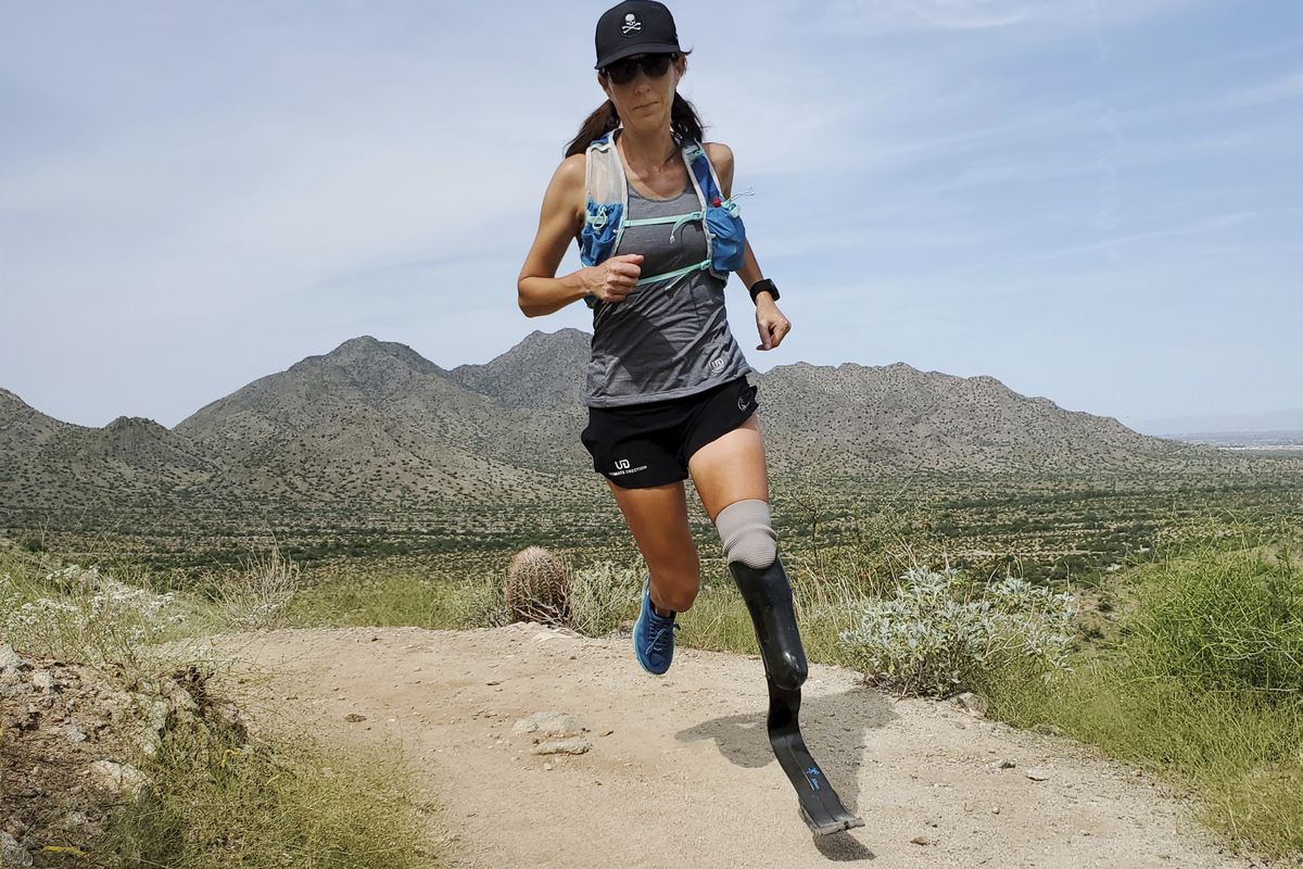 In this image provided by Edwin Broersma, marathoner Jacky Hunt-Broersma trains on Aug. 28, 2021 at San Tan Mountain Regional Park, in San Tan Valley, Az. Hunt-Broersma lost her left leg below the knee to a rare form of cancer, but she hasn